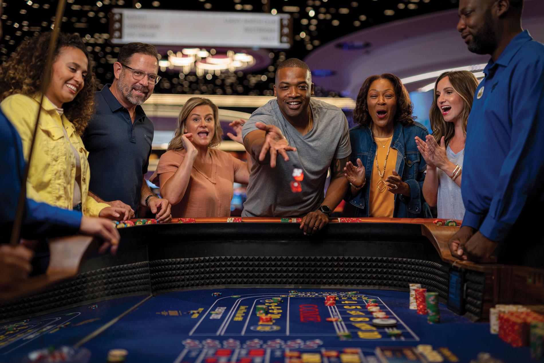 Man throwing dice down a table game at Southland Casino